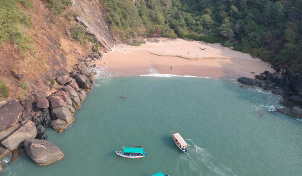 Aerial view of Butterfly Beach in Goa showing boats and secluded shore